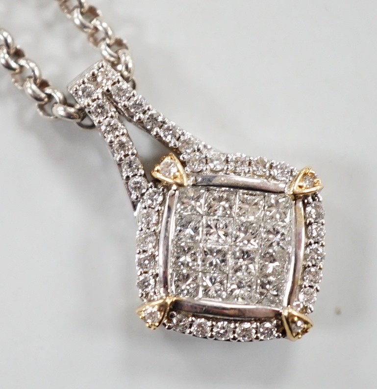 A modern 14k yellow and white metal, pave set diamond pendant, 23mm, on a Chinese? white metal chain, 34cm.